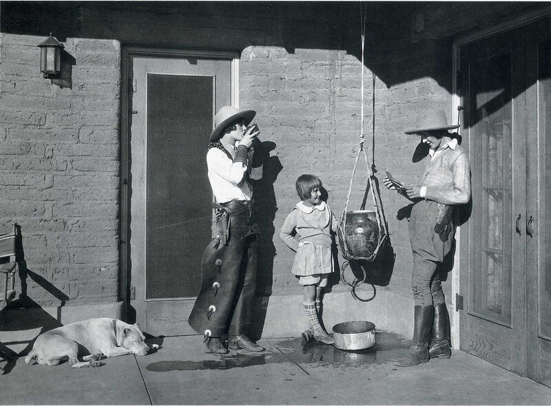 Cowboys with child on porch
