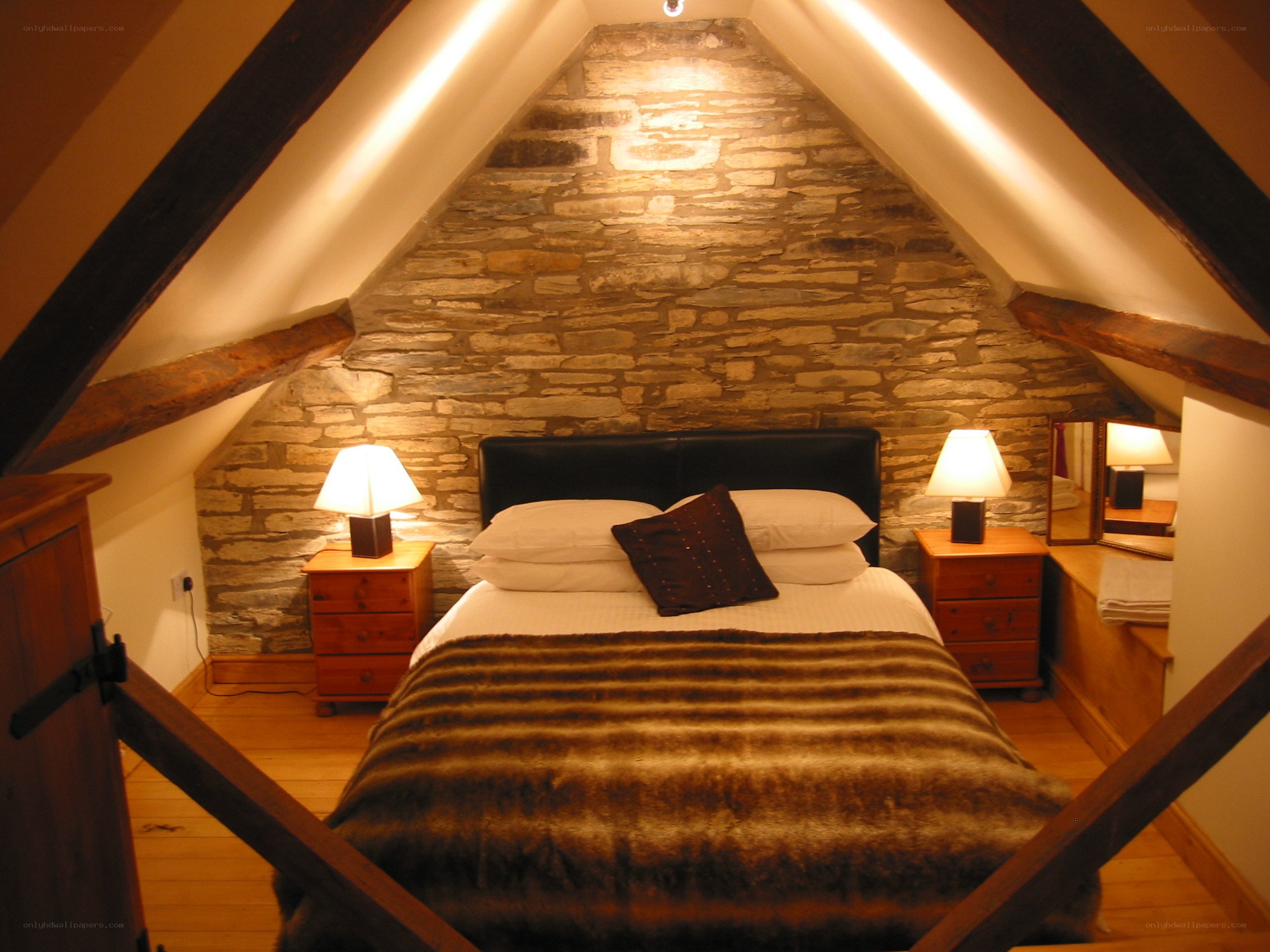 Cozy attic bedroom with stone wall