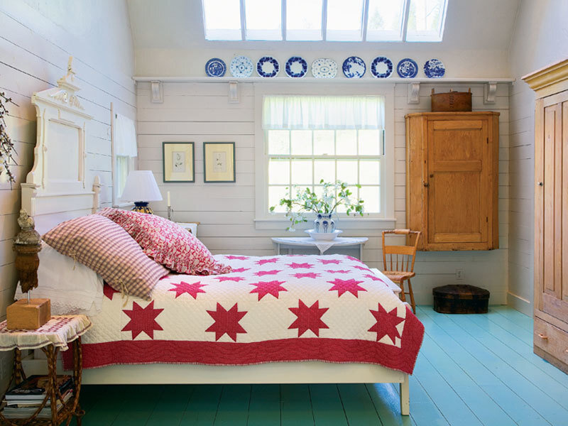 cozy bedroom with quilt and blue floor
