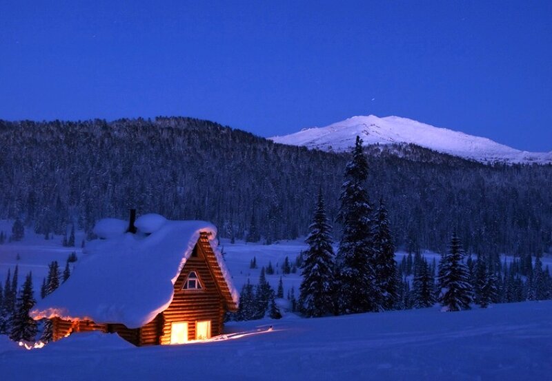 Cozy cabin in snowy mountains