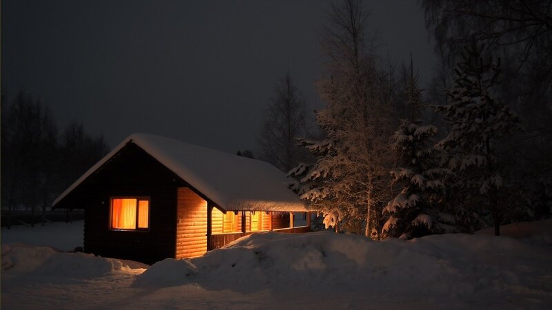 Cozy cabin in snowy night