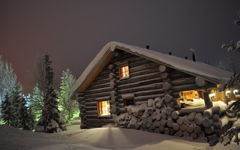 Cozy cabin in snowy night