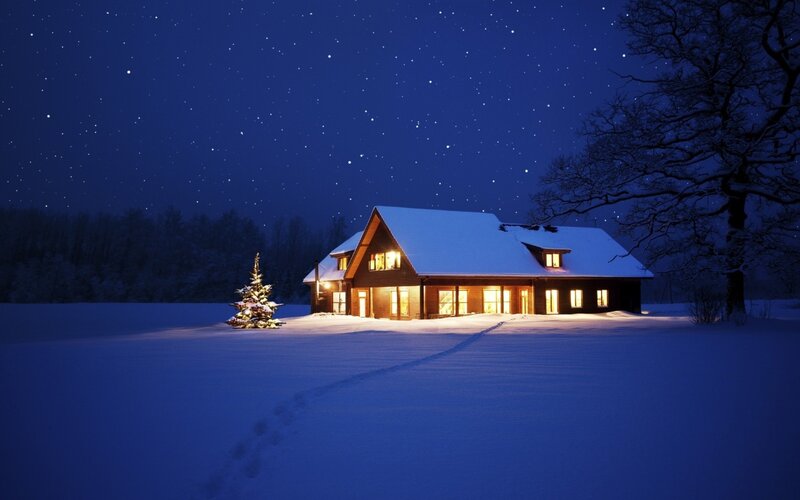 Cozy cabin in snowy night