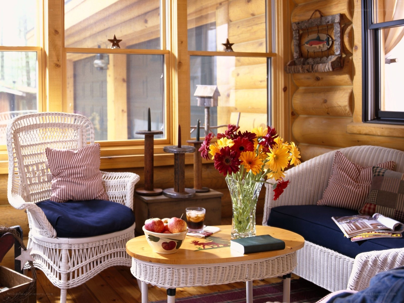 Cozy cabin sunroom with wicker furniture