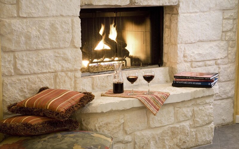 Cozy fireplace with wine and books