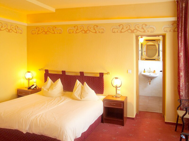 Cozy hotel room with yellow walls