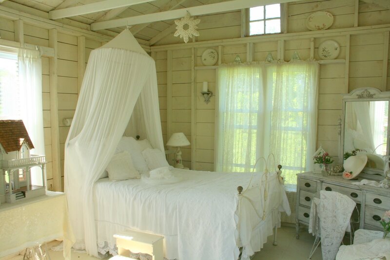 cozy white bedroom with canopy bed