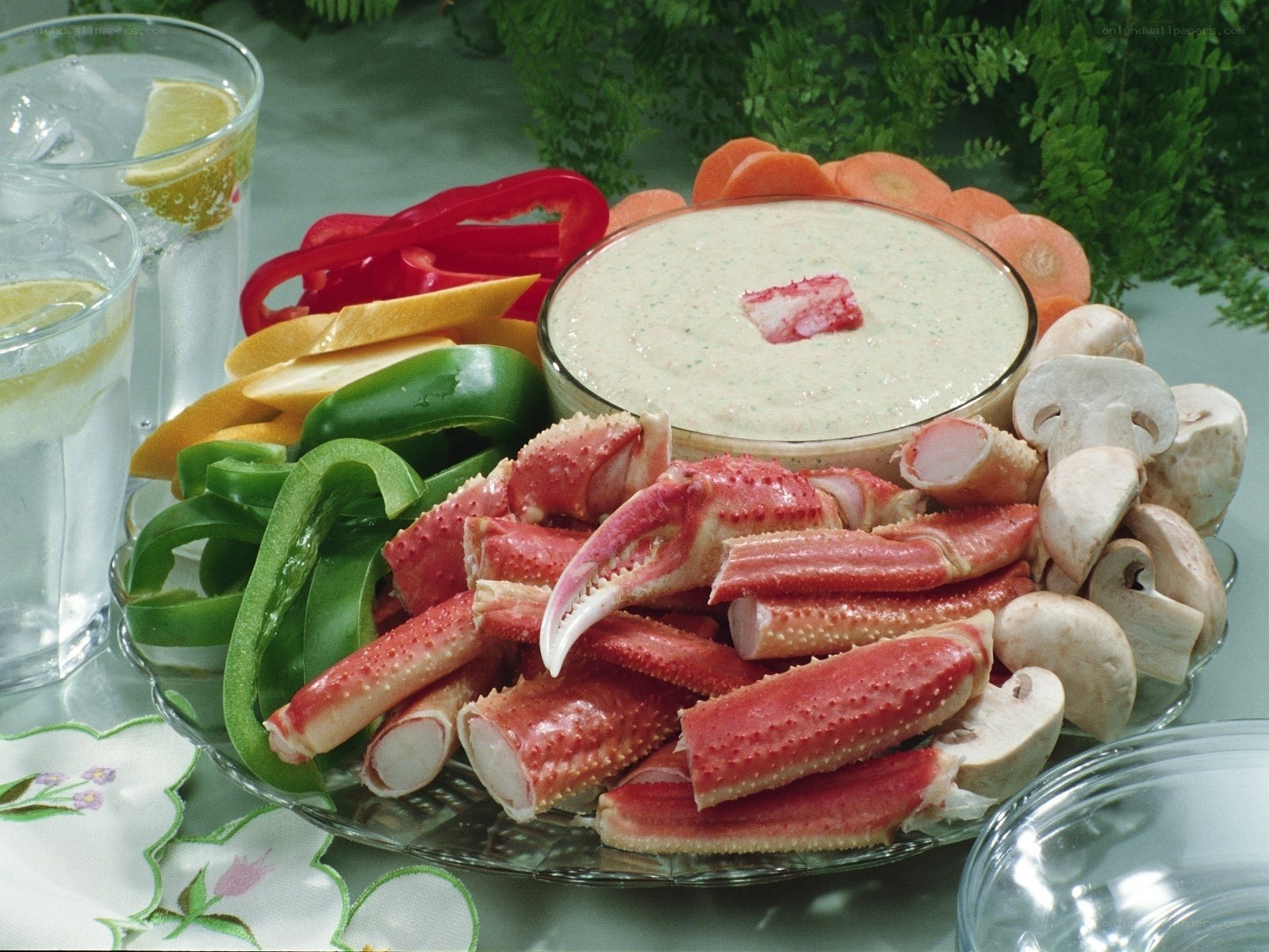 crab legs with dip and vegetables