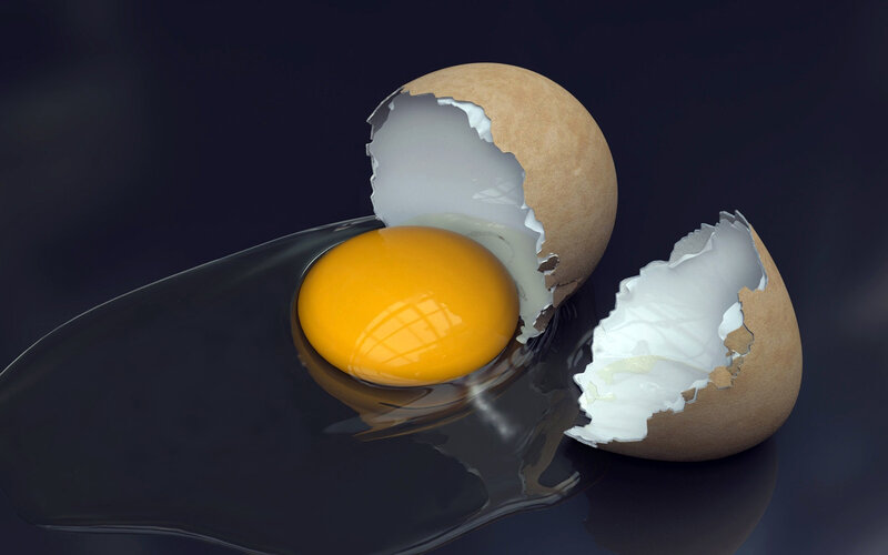 cracked egg on dark surface