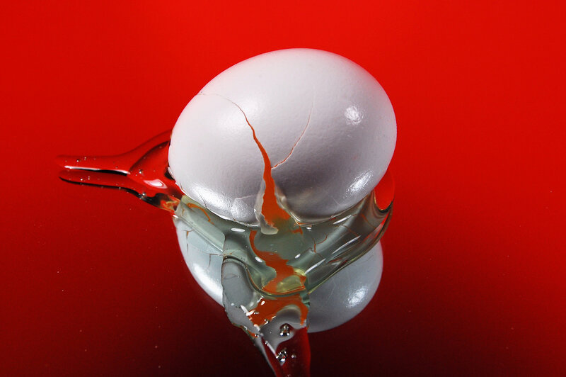 Cracked Egg on Red Surface