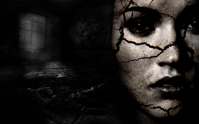 cracked face in dark room