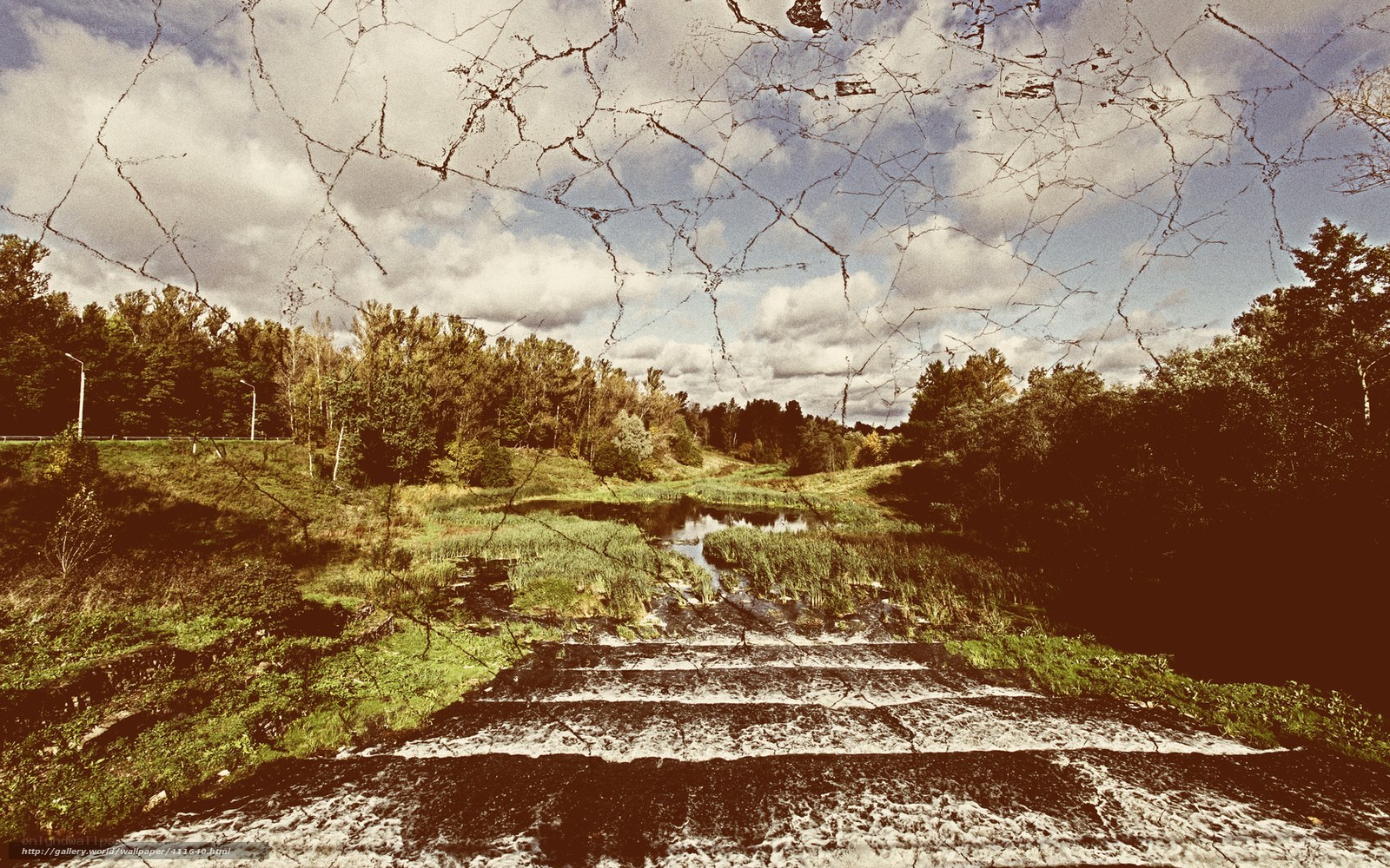 Cracked glass over a river scene