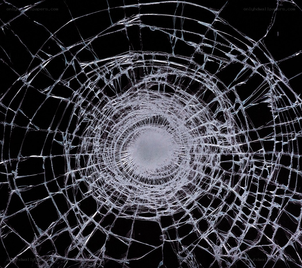 cracked glass with bullet hole
