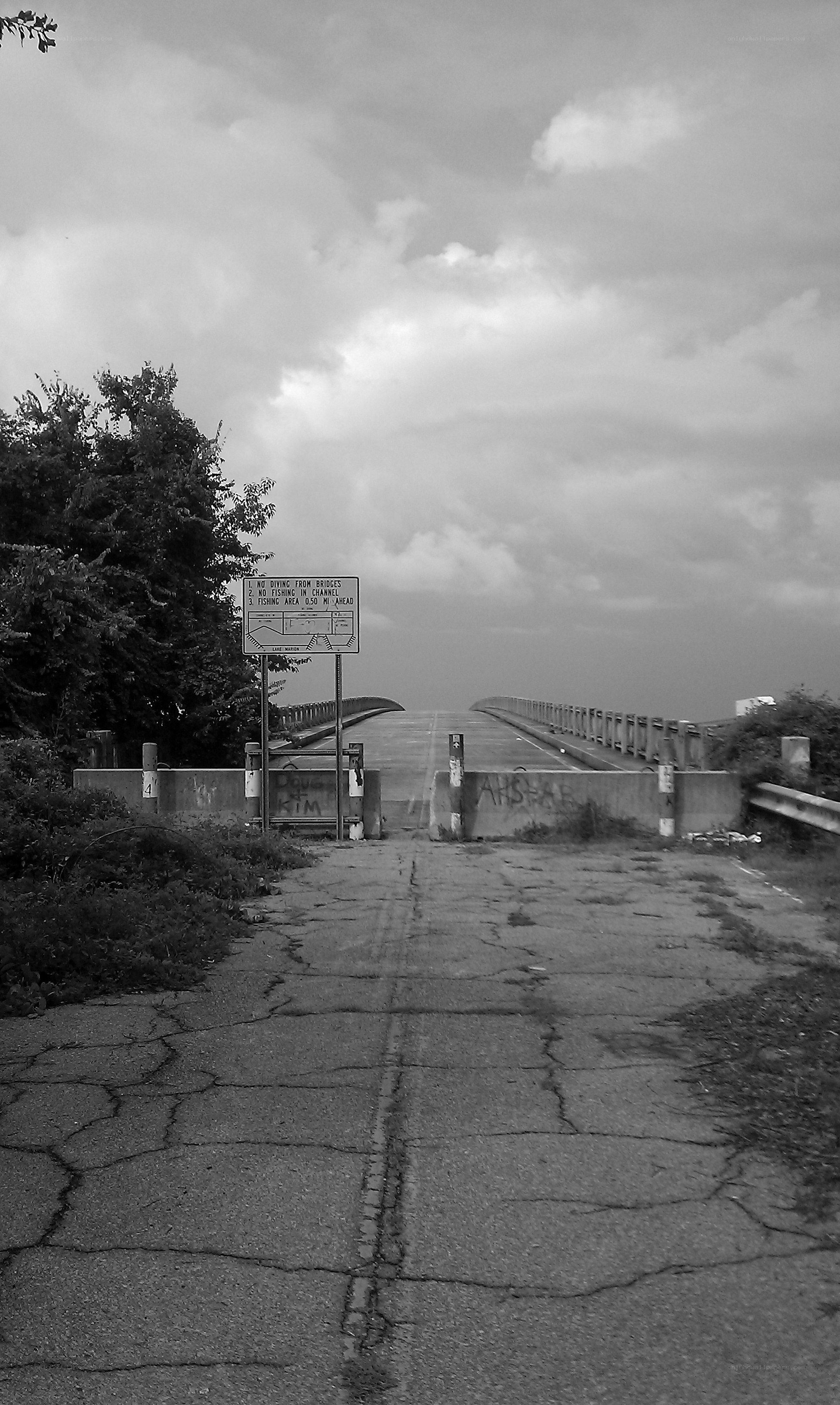 Cracked pavement leads to a bridge