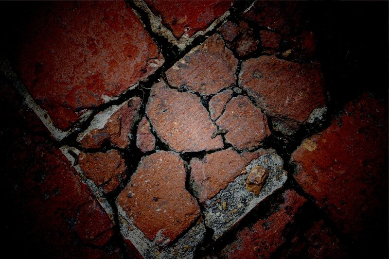 cracked red brick pavement
