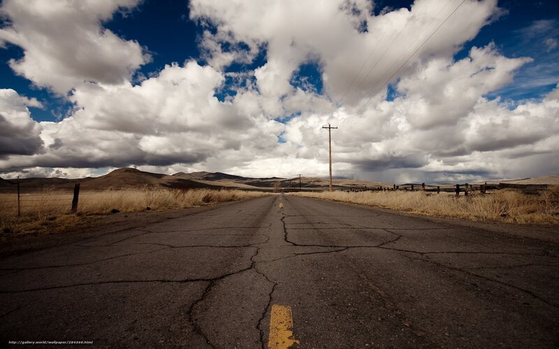 cracked road under cloudy sky