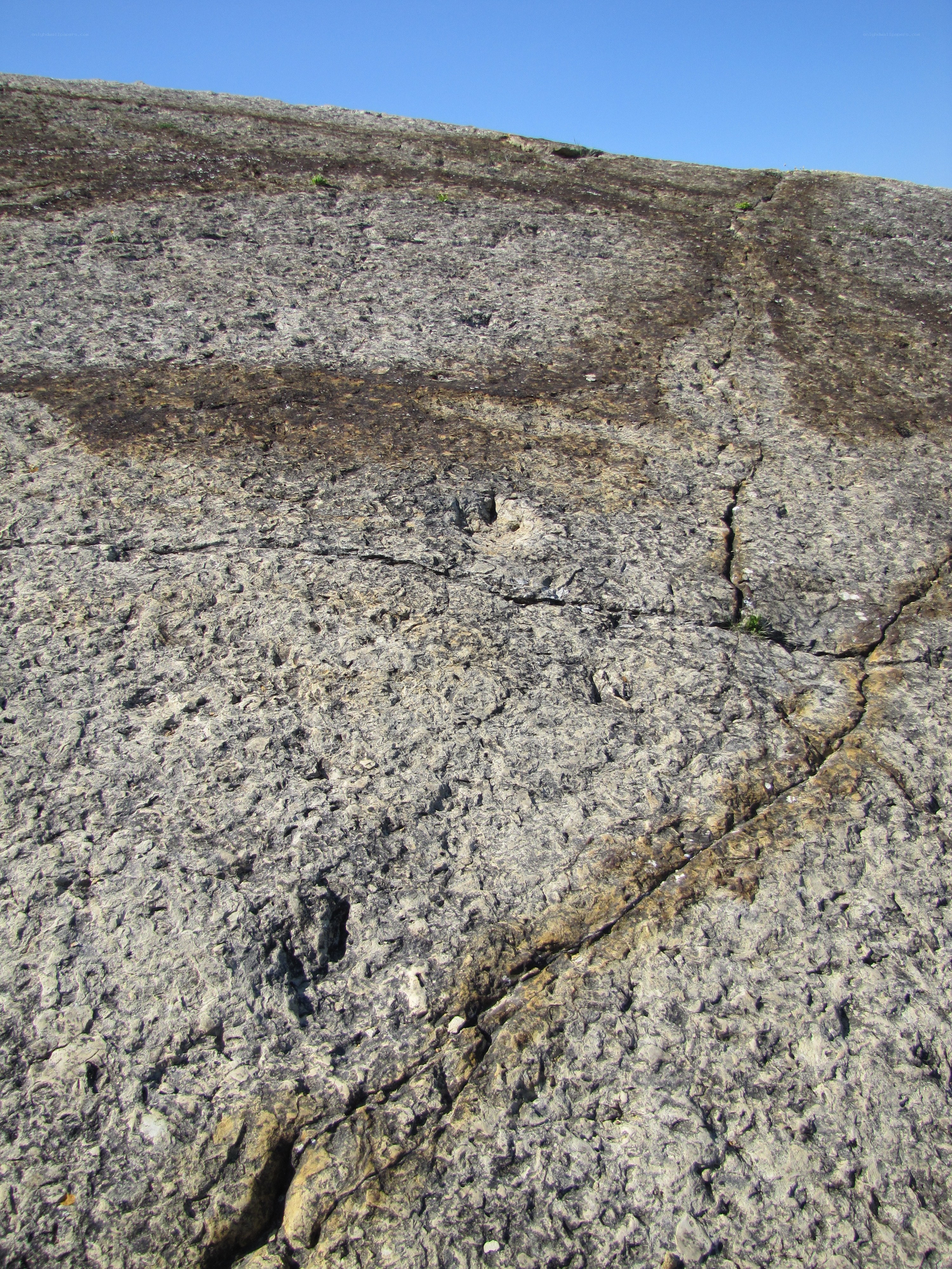 cracked rock surface under blue sky