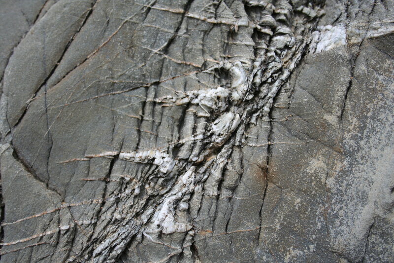 cracked rock with mineral veins