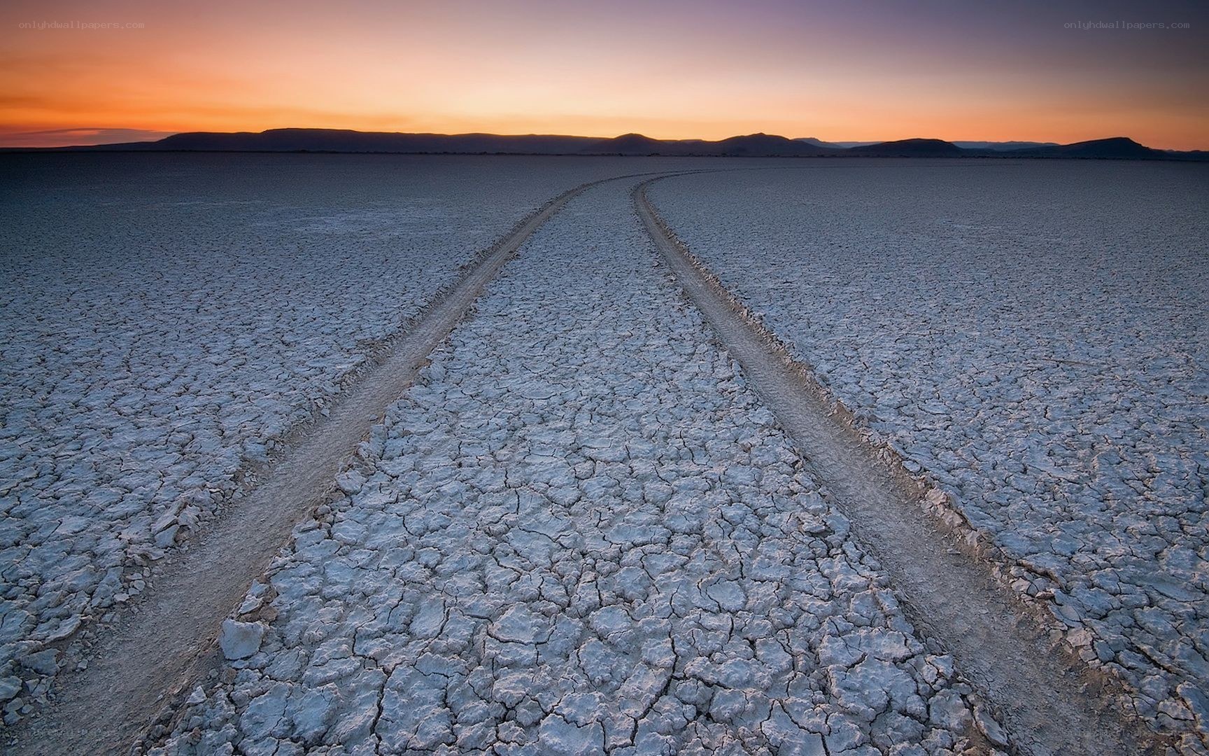 Cracked salt flat at sunset