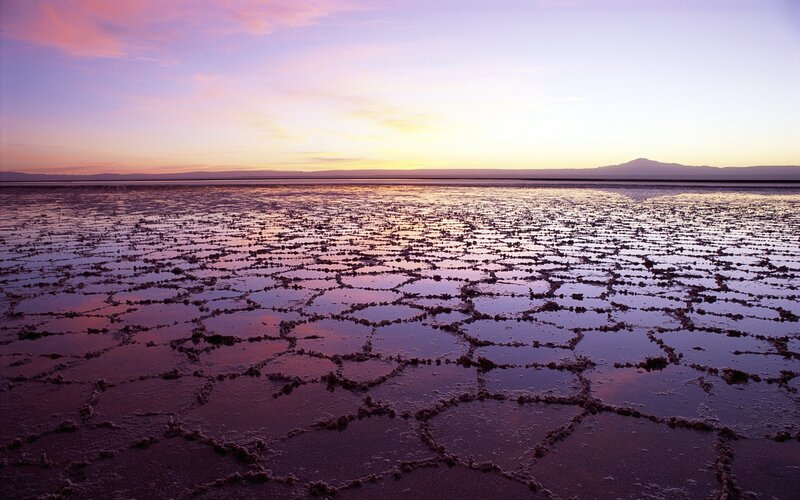 Cracked salt flat at sunset