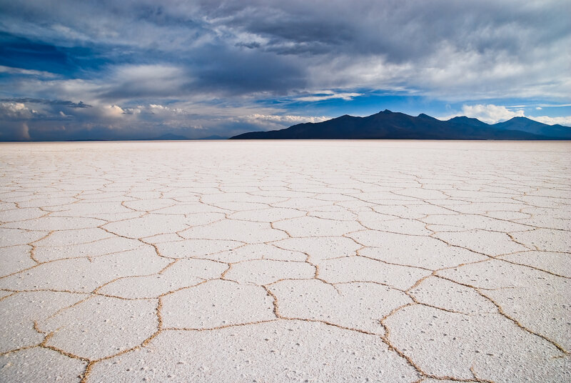 Cracked salt flat under stormy sky