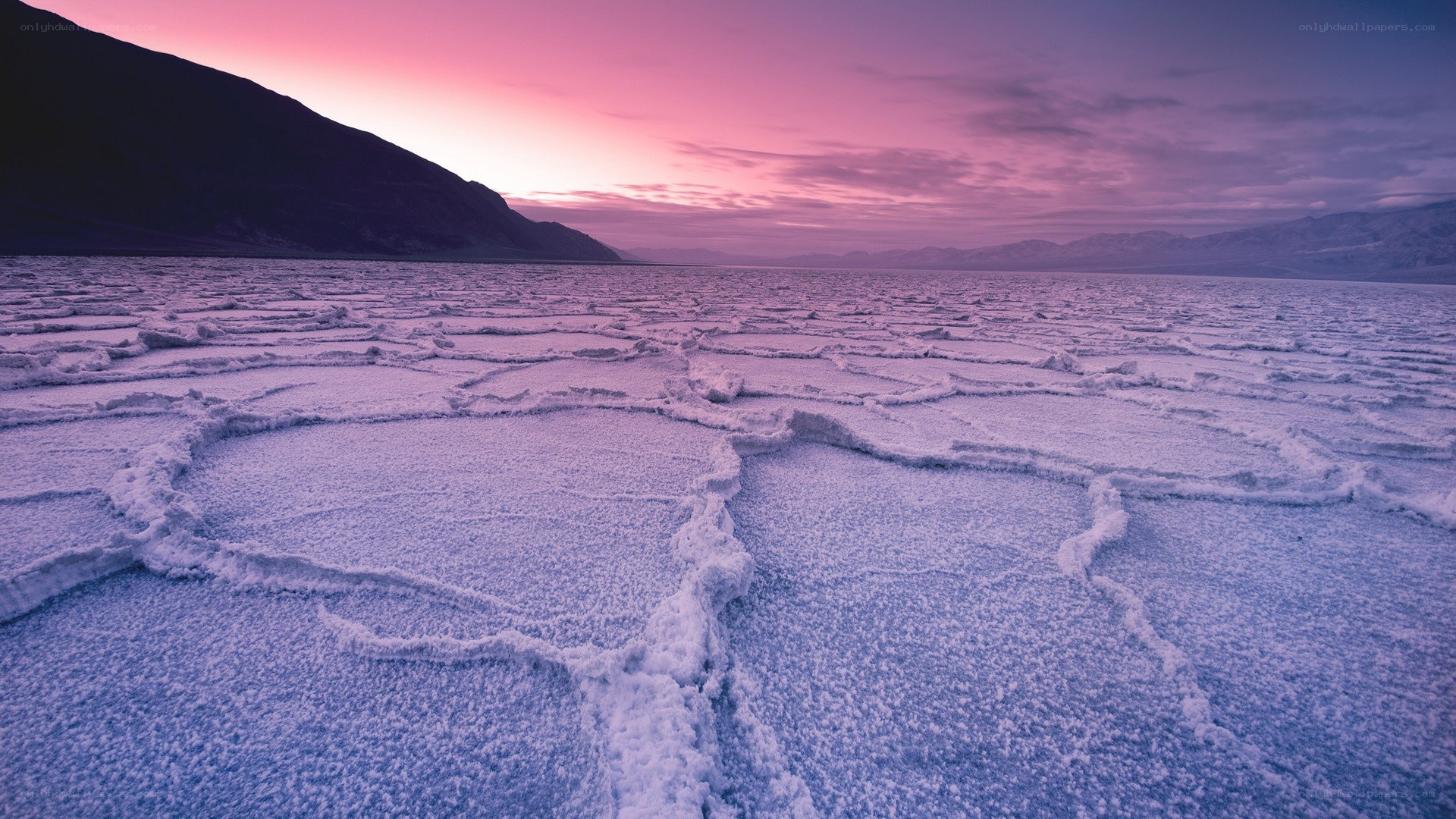 Cracked salt flats at sunset