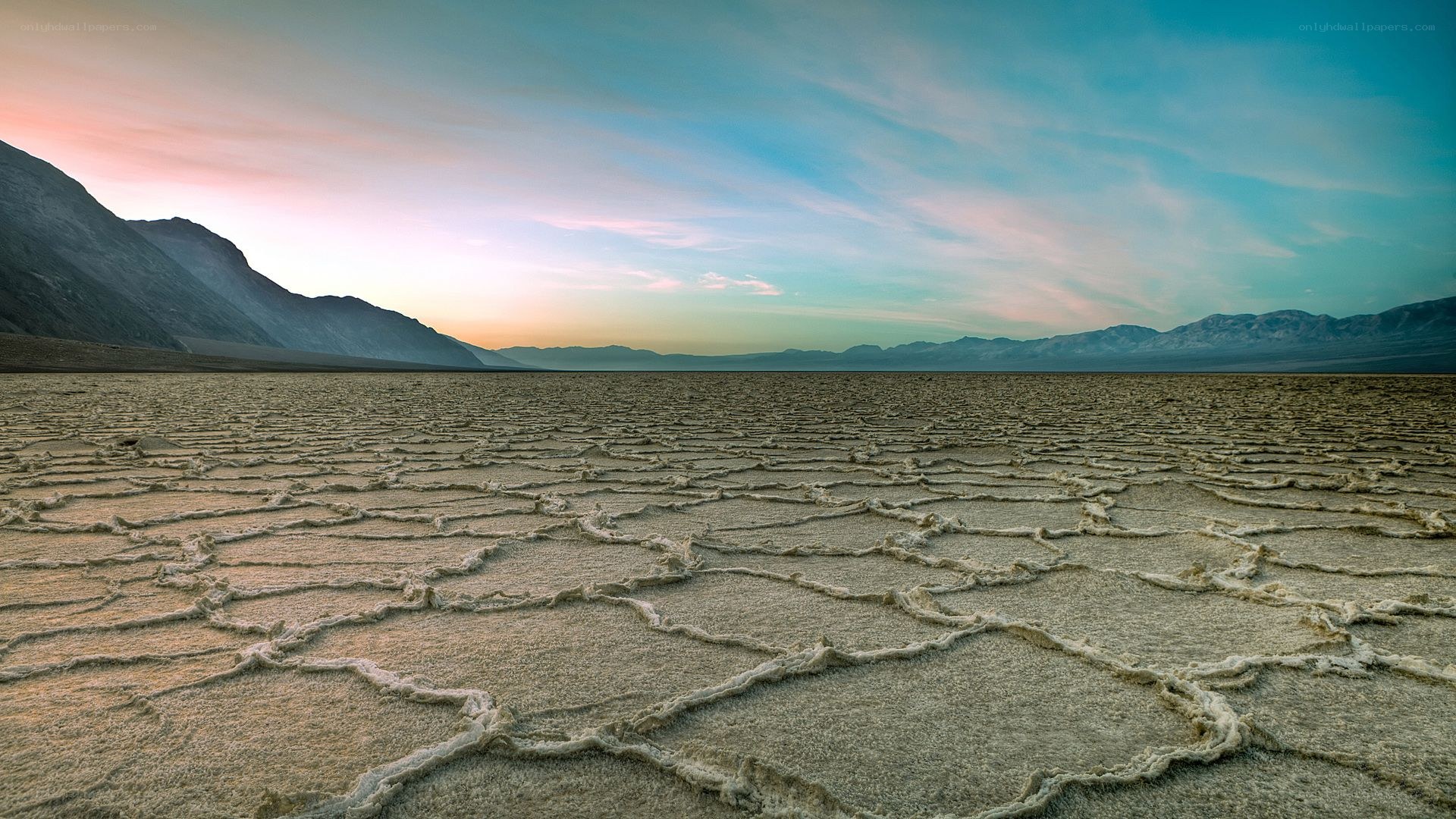 Cracked salt flats at sunset