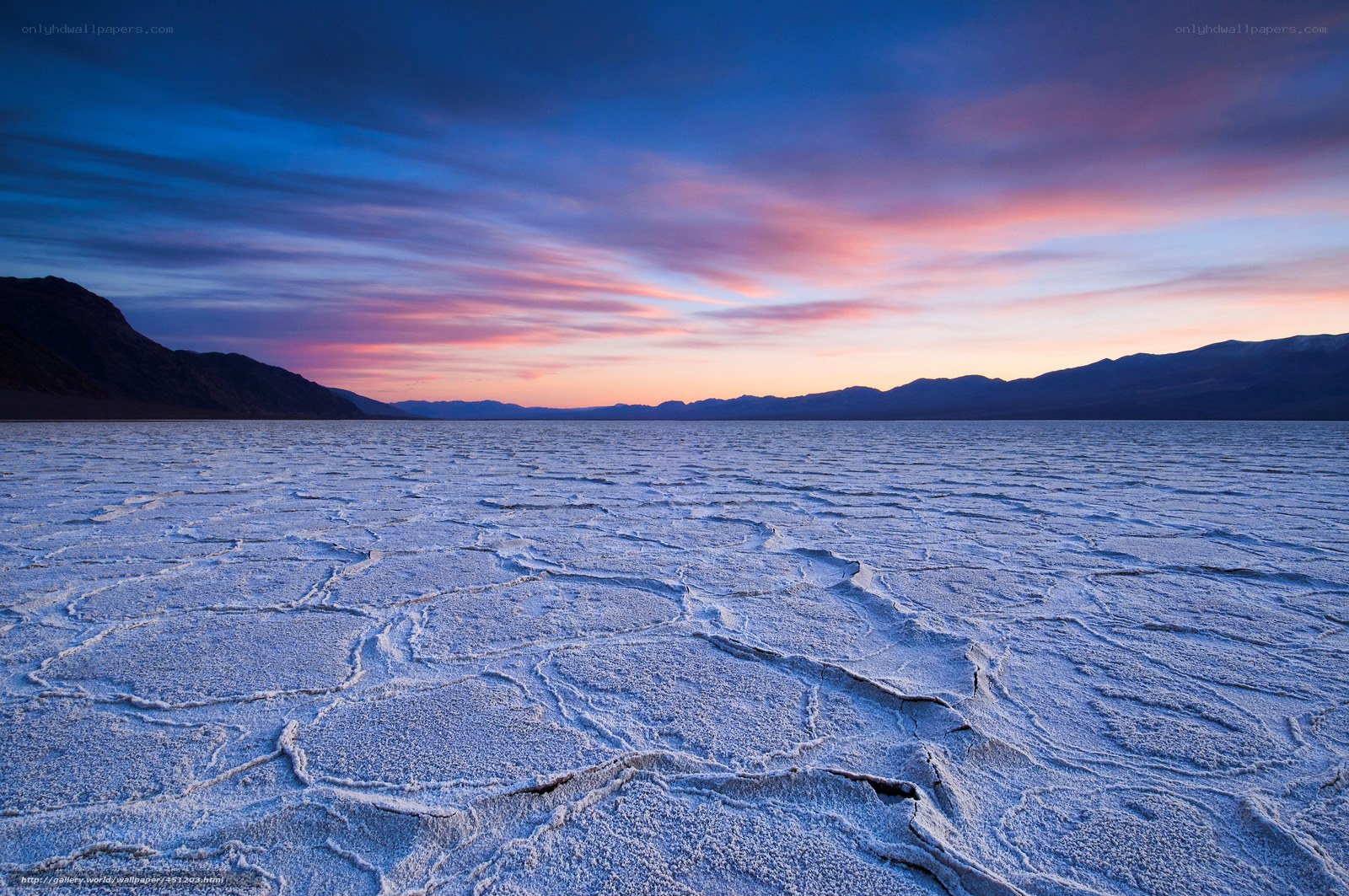 Cracked salt flats at sunset