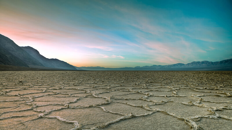 Cracked salt flats at sunset
