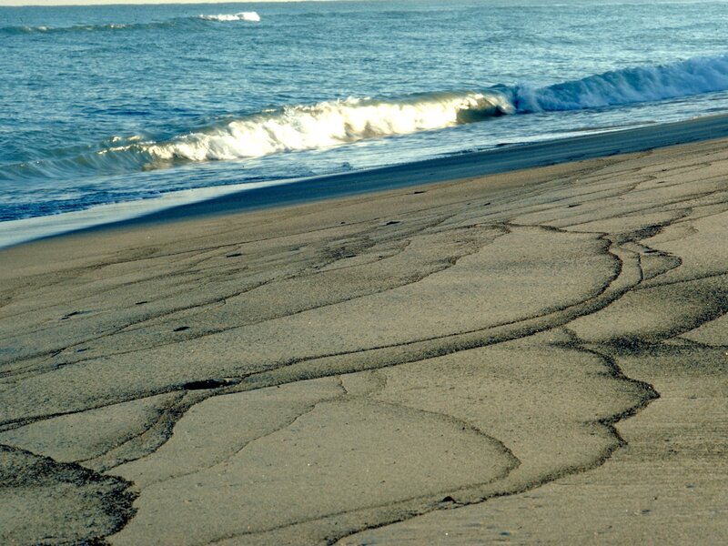 cracked sand at the ocean's edge