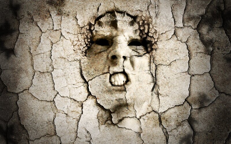 cracked stone face sculpture