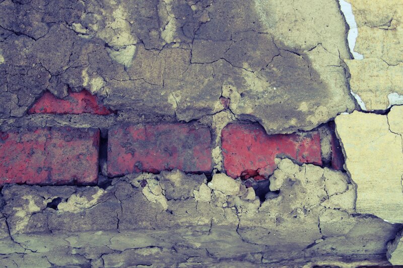 cracked wall with red bricks