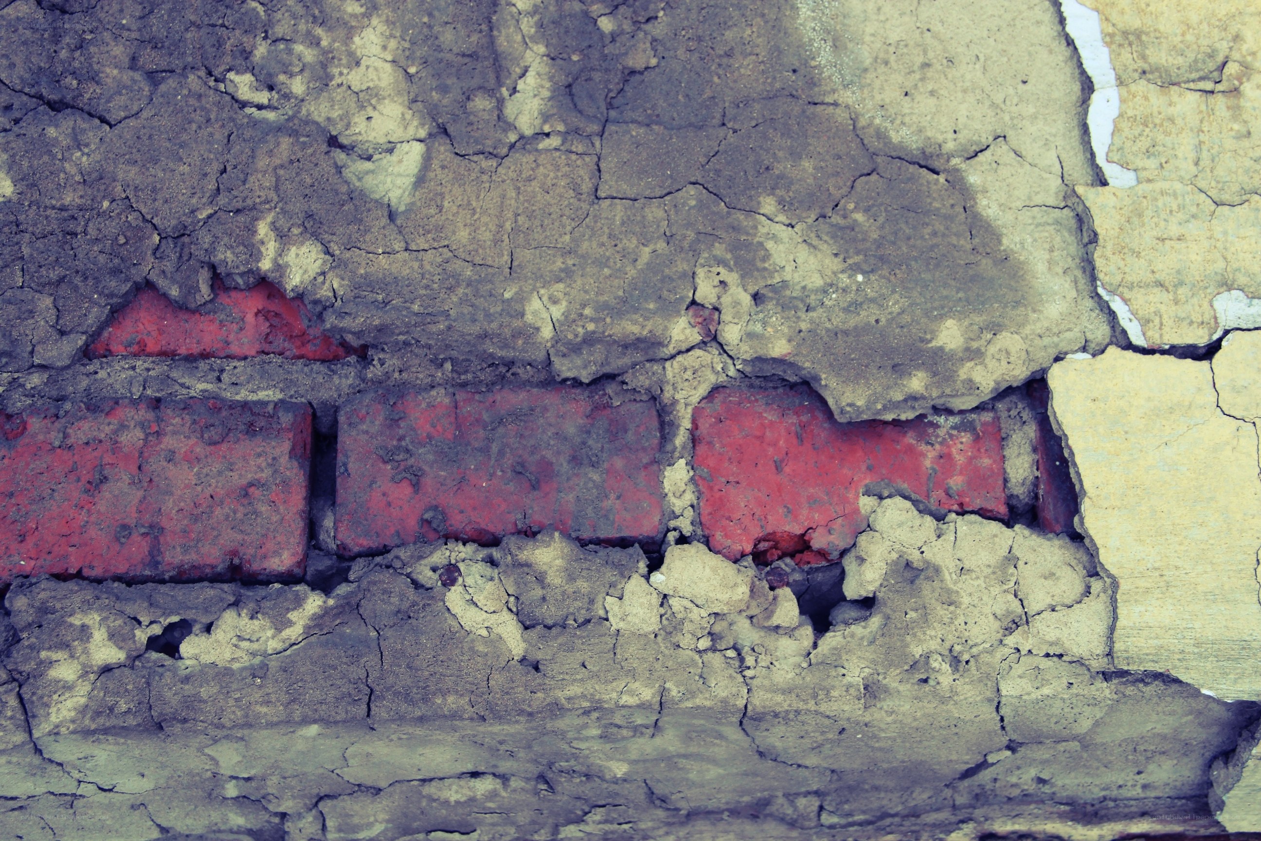 cracked wall with red bricks