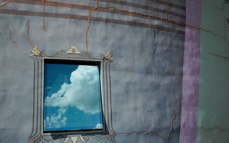 cracked wall with window reflection
