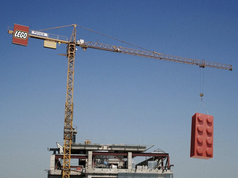 Crane lifting giant Lego brick