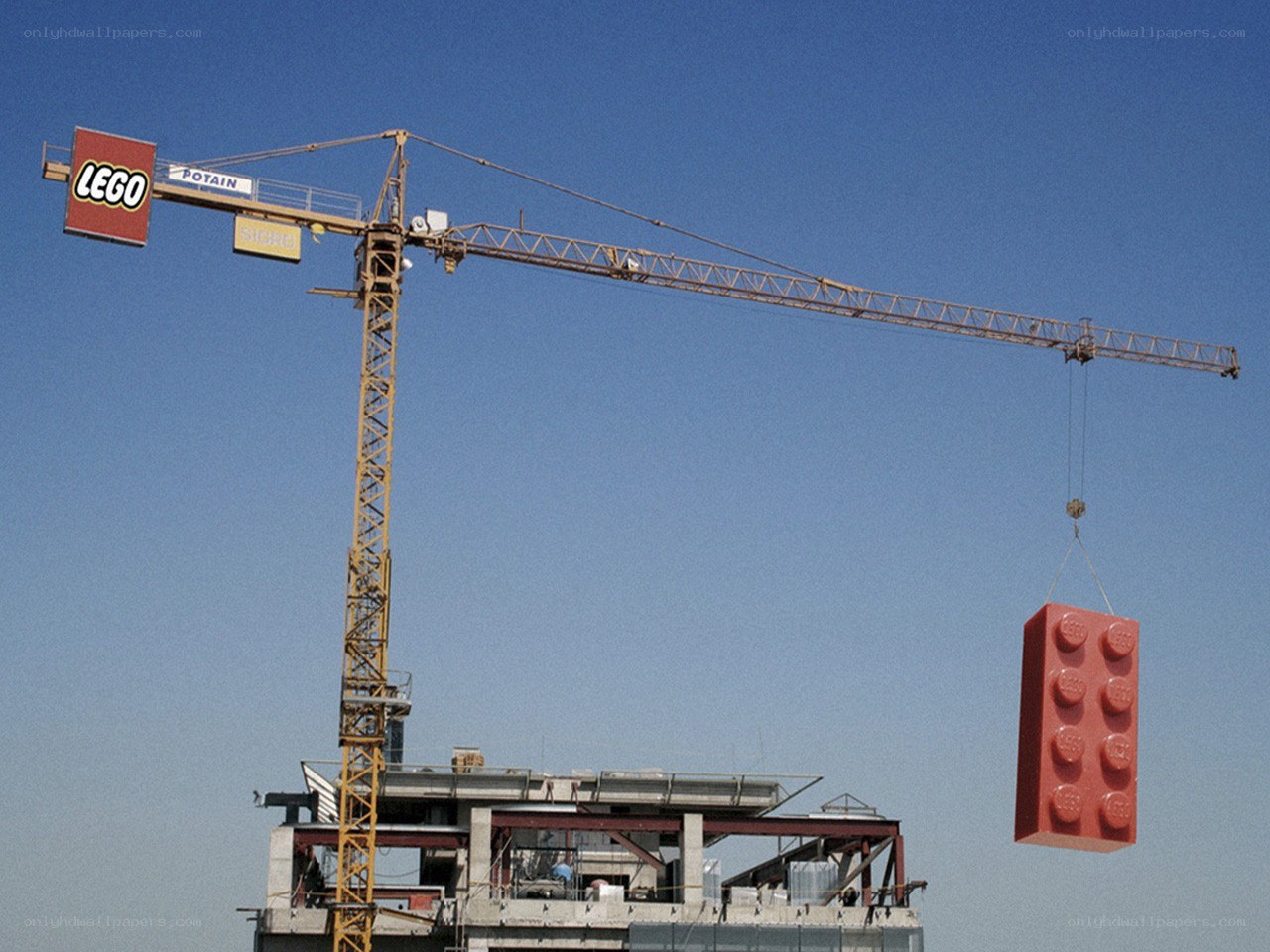 Crane lifting giant Lego brick