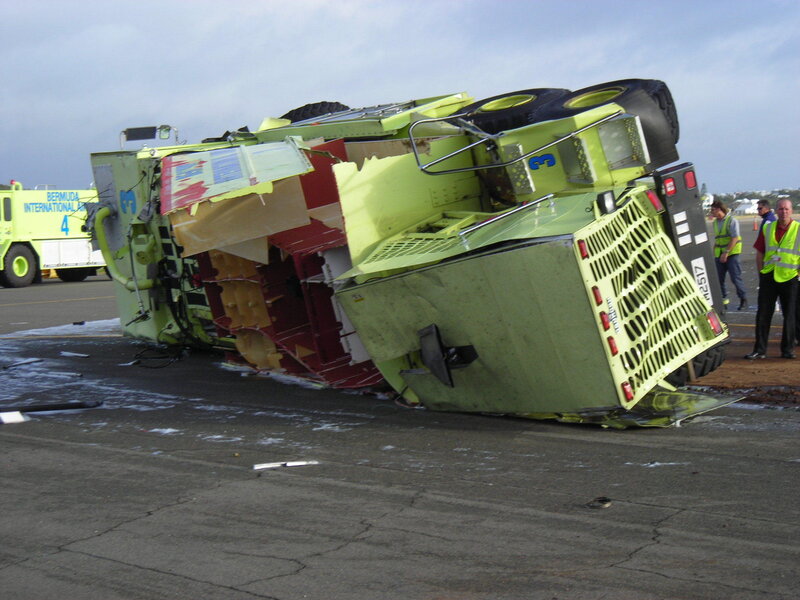 Crashed airport vehicle on tarmac