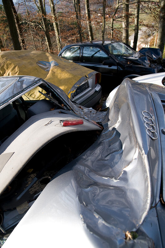 Crashed cars in a wooded area
