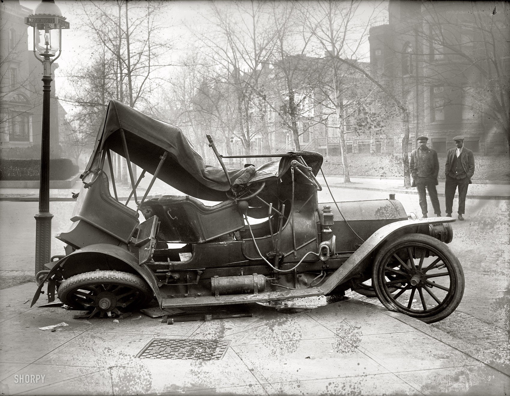 Crashed vintage car on sidewalk