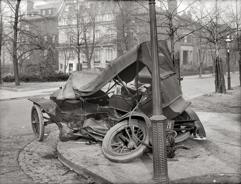 Crashed vintage car on sidewalk