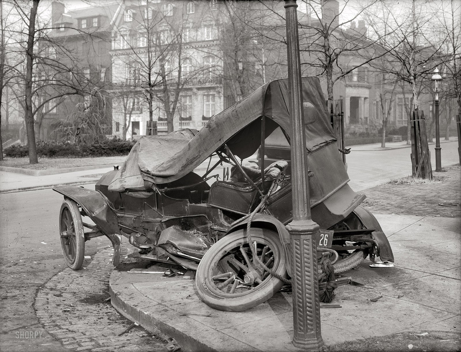 Crashed vintage car on sidewalk
