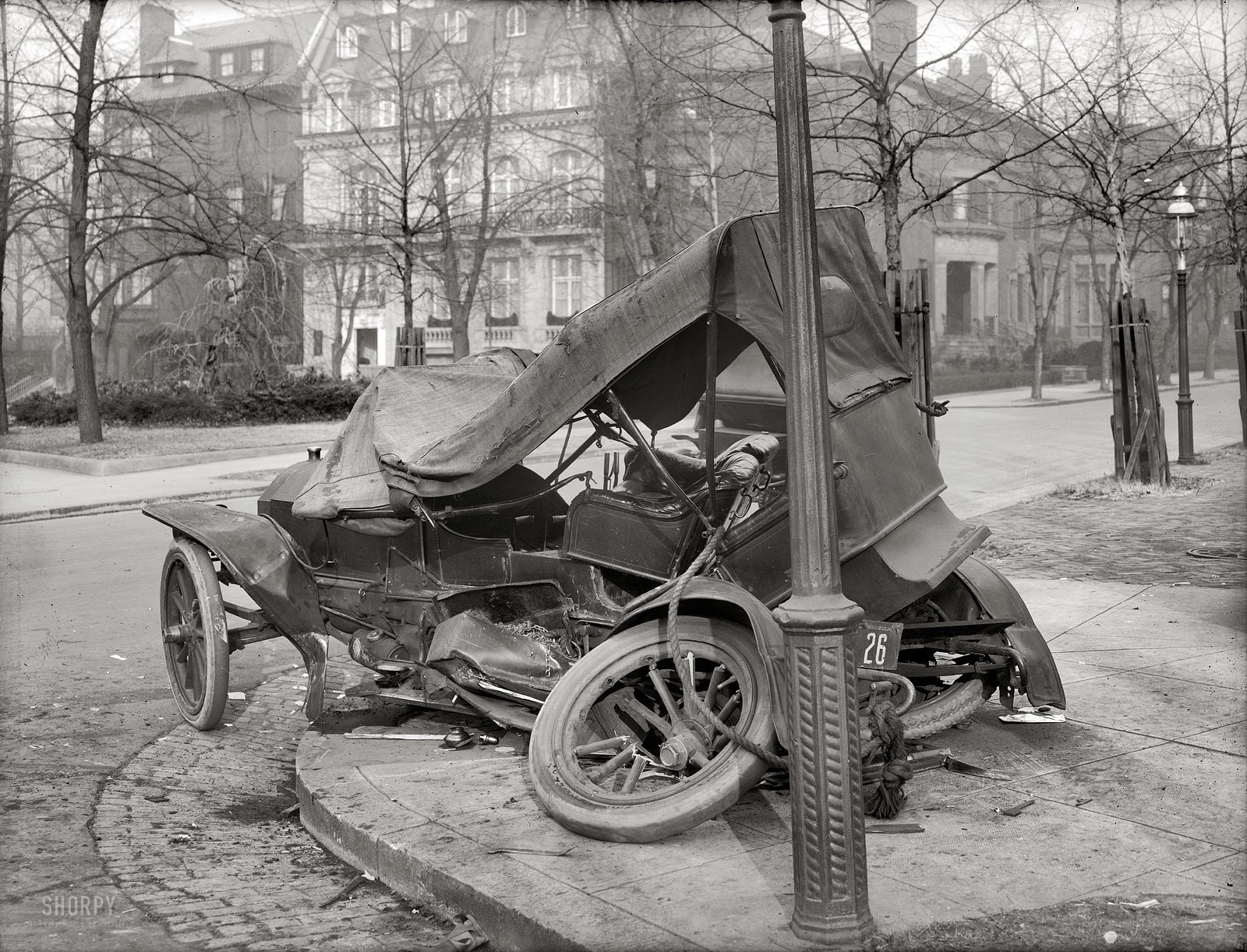 Crashed vintage car on sidewalk