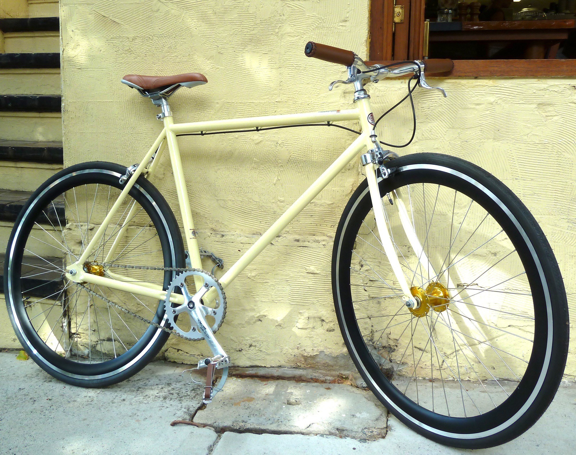 cream-colored bicycle against wall