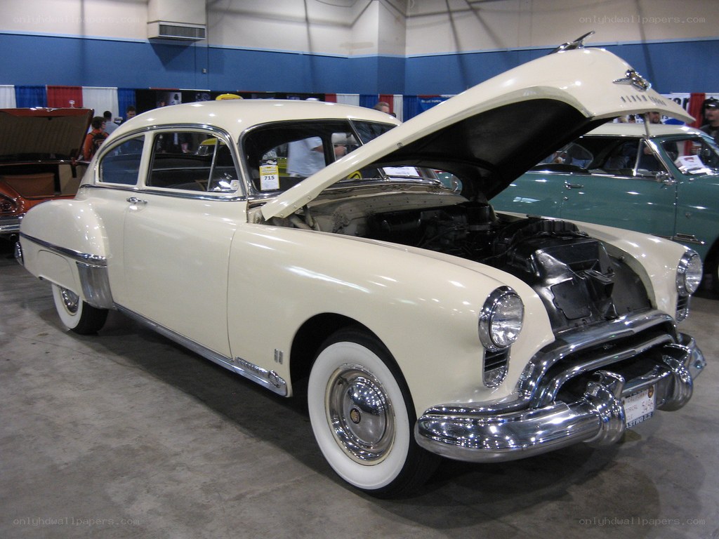cream-colored classic car on display