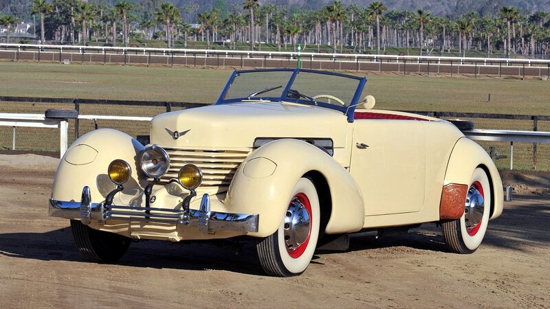 Cream convertible car at racetrack