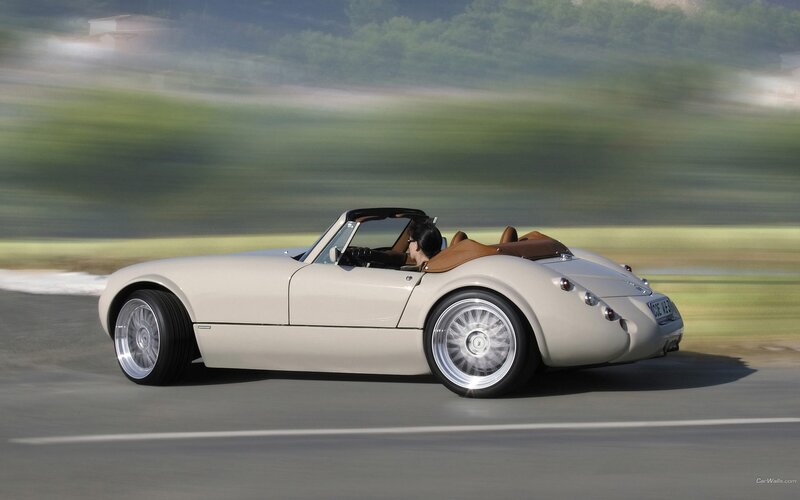 Cream convertible sports car in motion