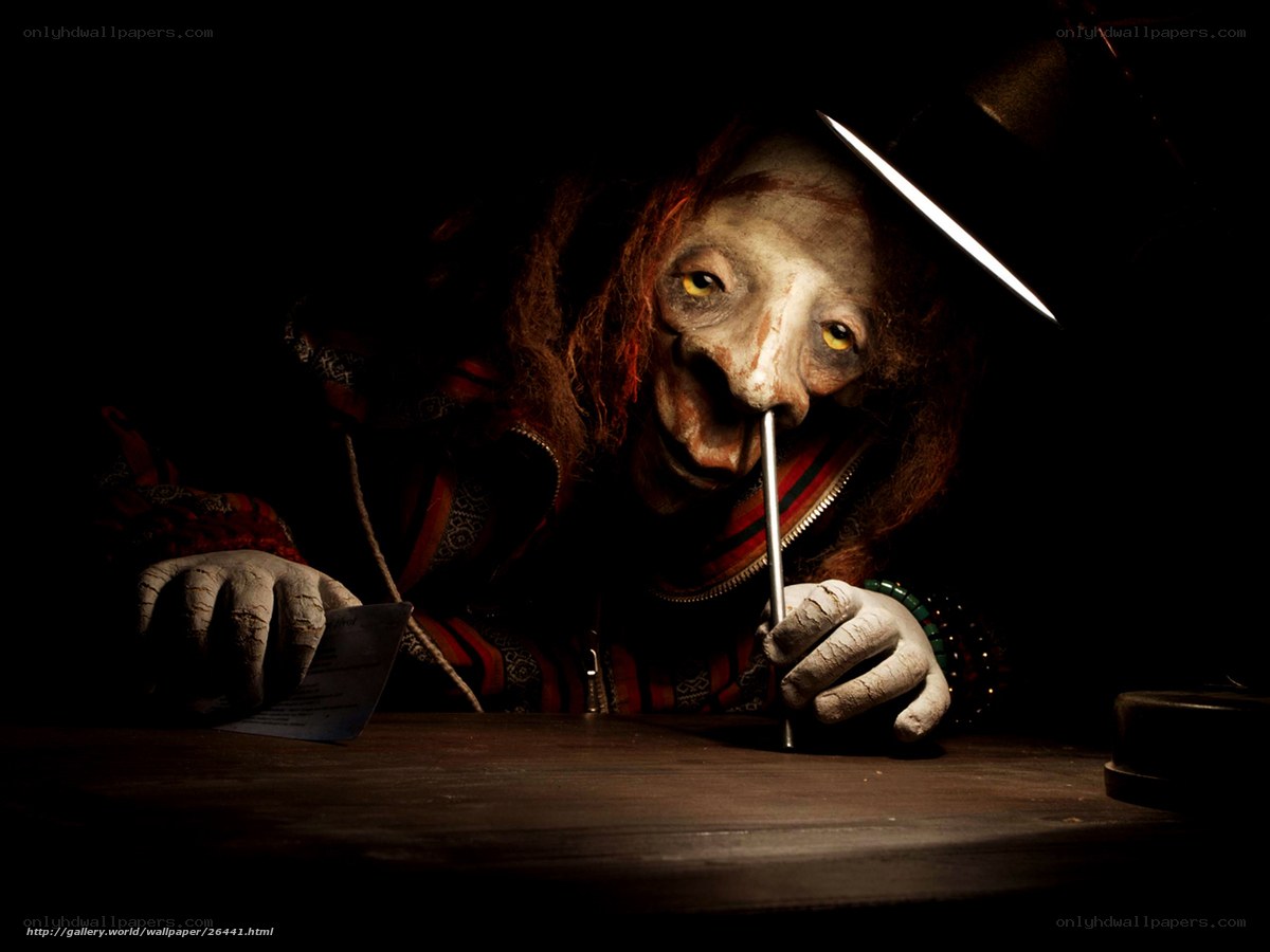 creepy figure writing at desk