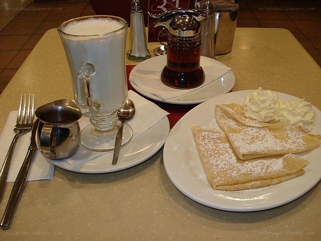 Crepes and milk drink on table