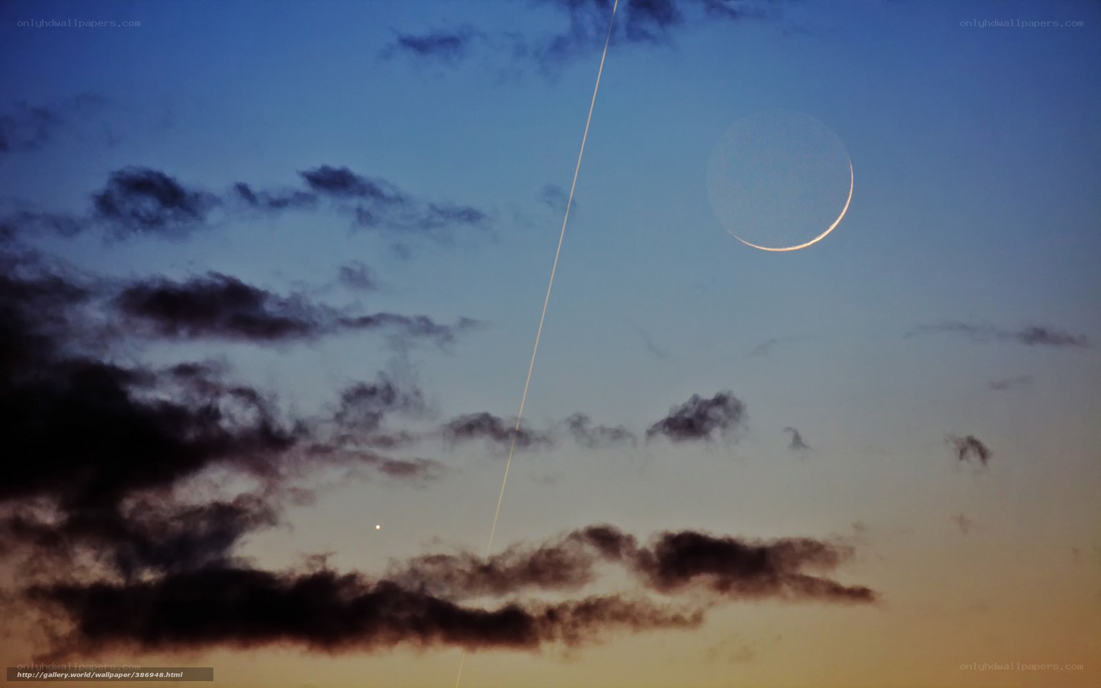 Crescent moon and airplane trail
