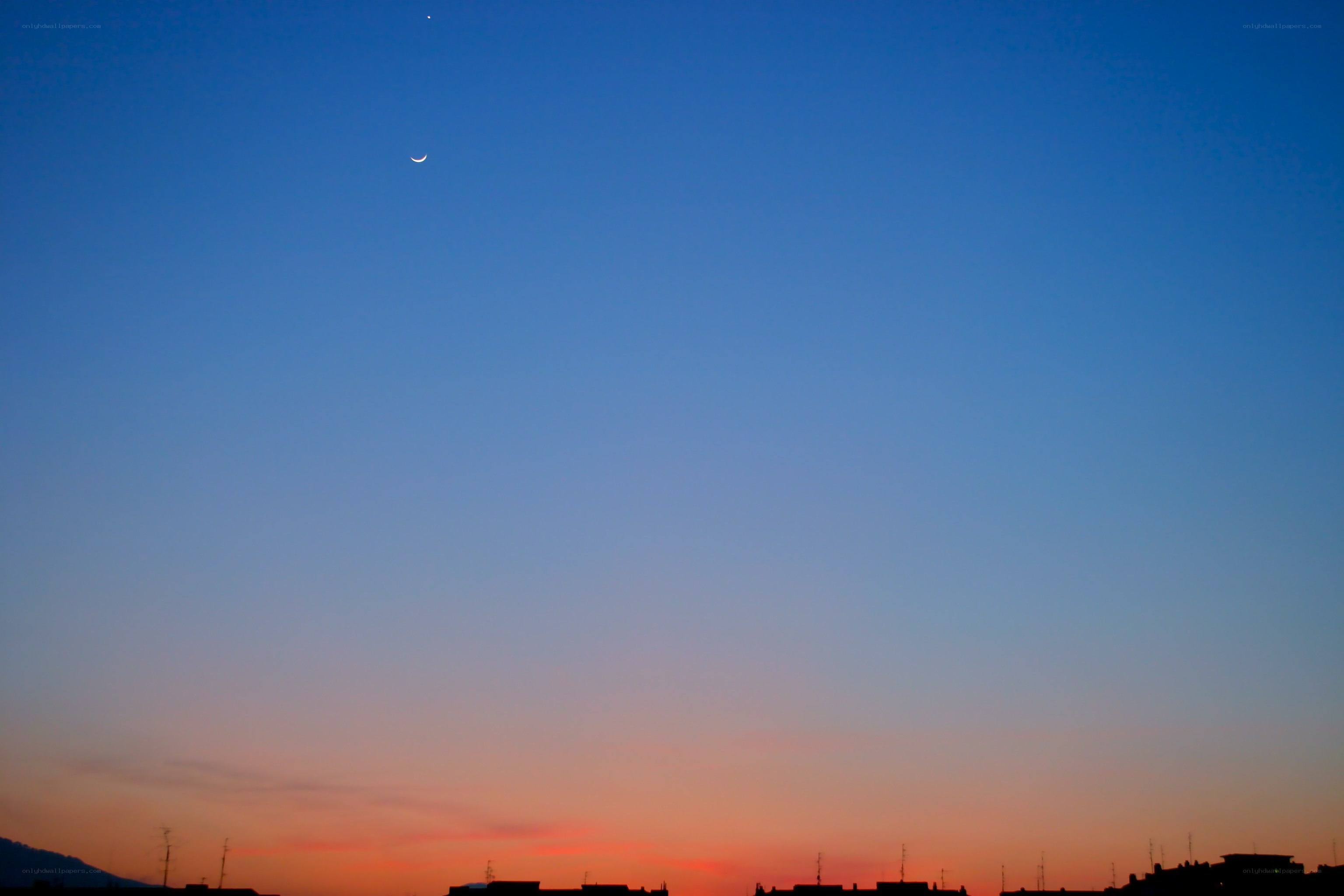 Crescent moon and planet at dusk